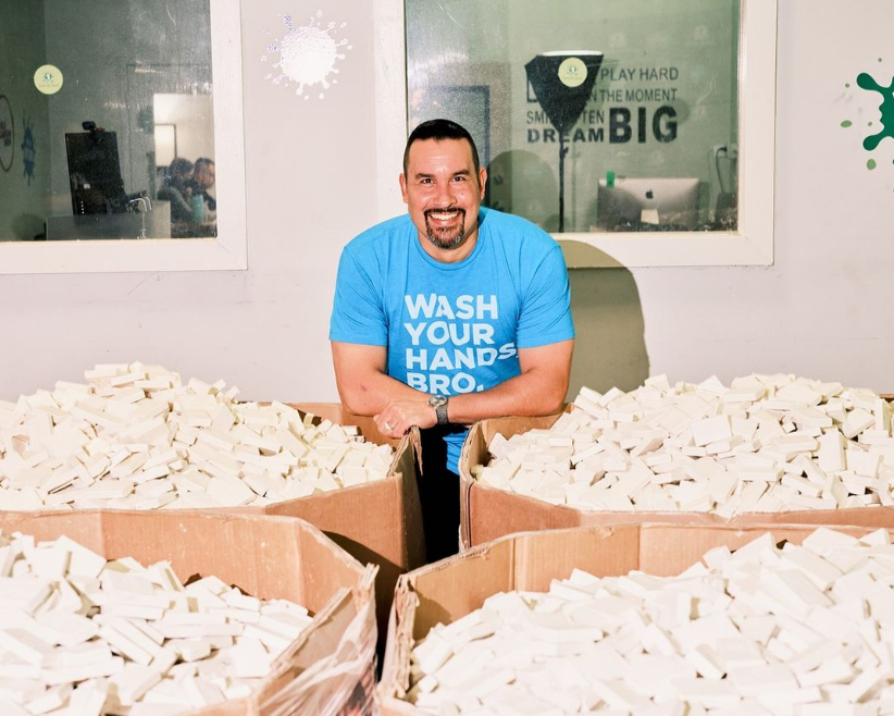 Shawn Seipler with gaylords full of soap